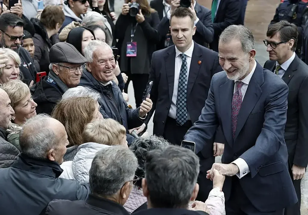 El rey Felipe VI saluda a vecinos a su llegada a L'Hospitalet de Llobregat.